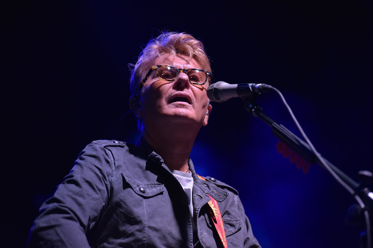 il cantante Ron si esibisce sul palco con microfono e chitarra